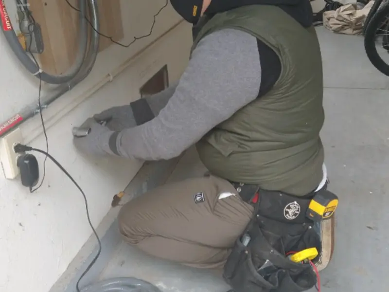 Electrician performing outlet wiring in a La Habra Heights garage
